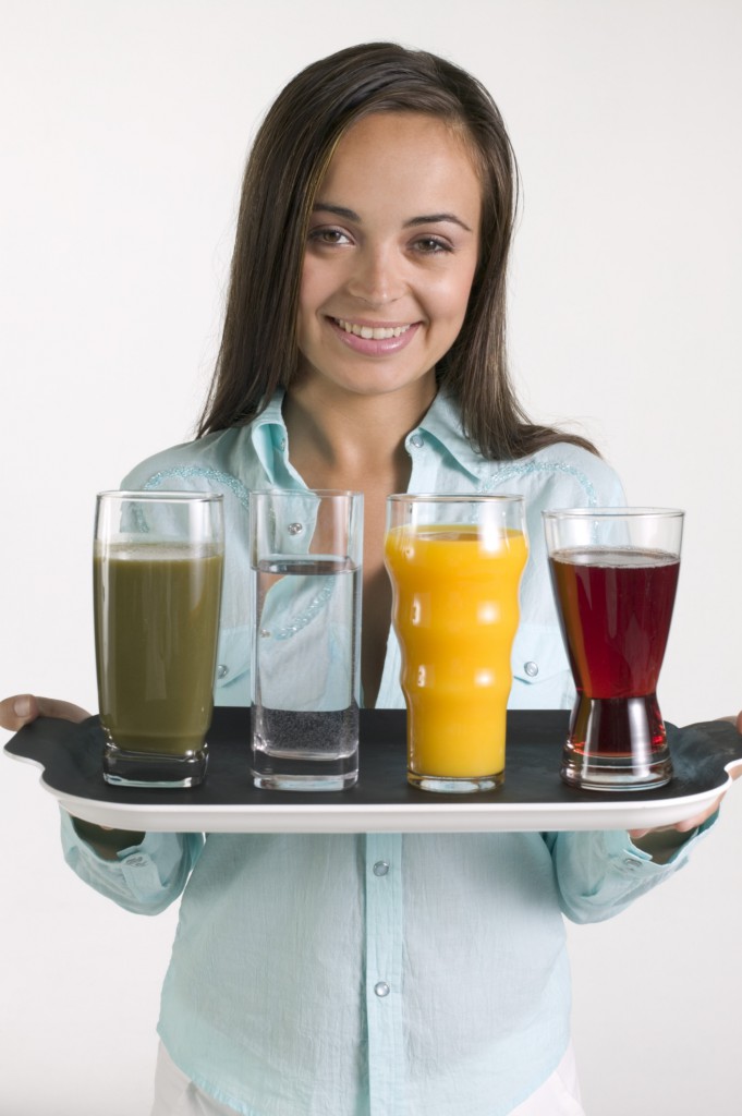 Woman holding tray with juice